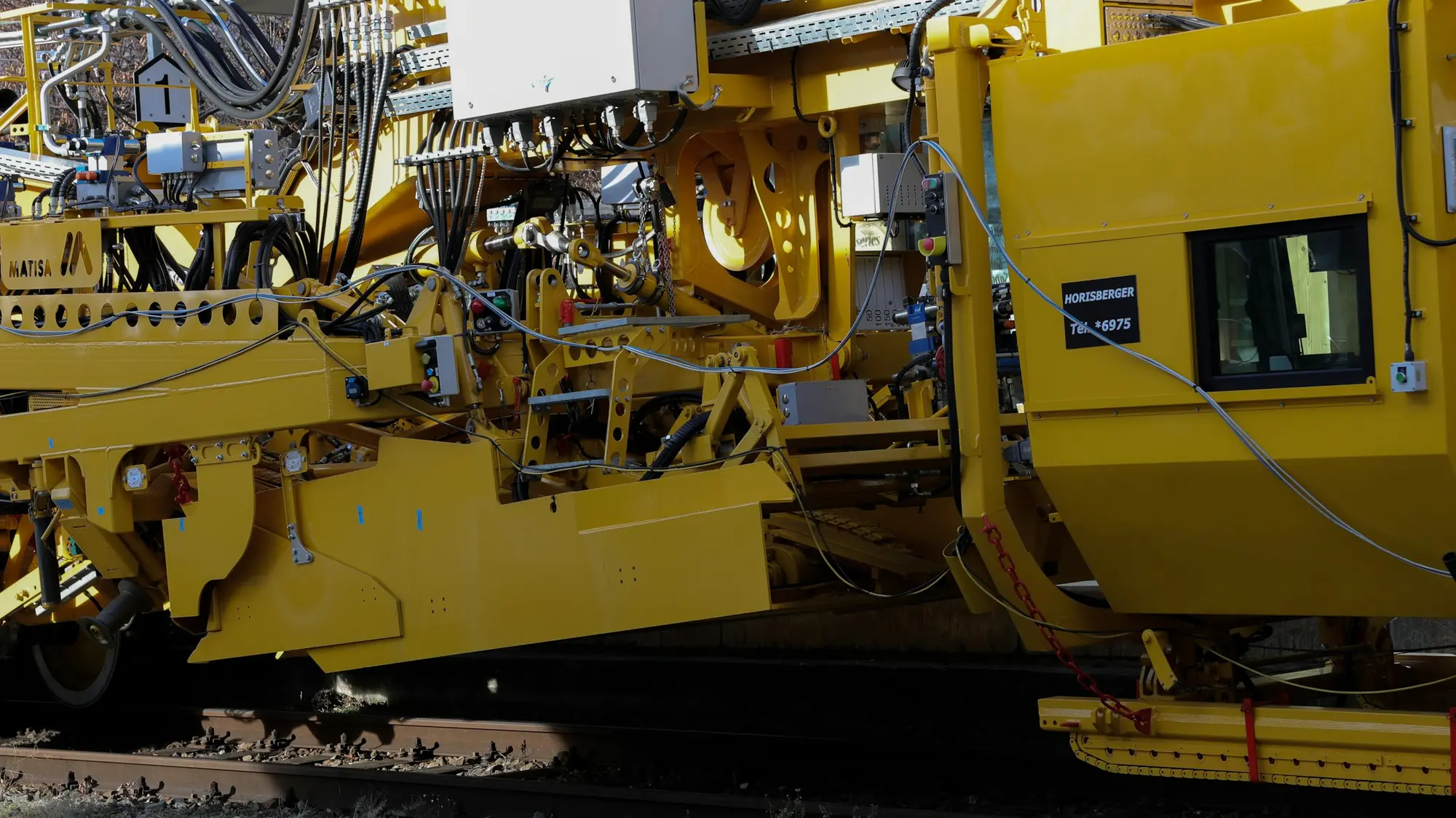 Track maintenance machine on railway tracks