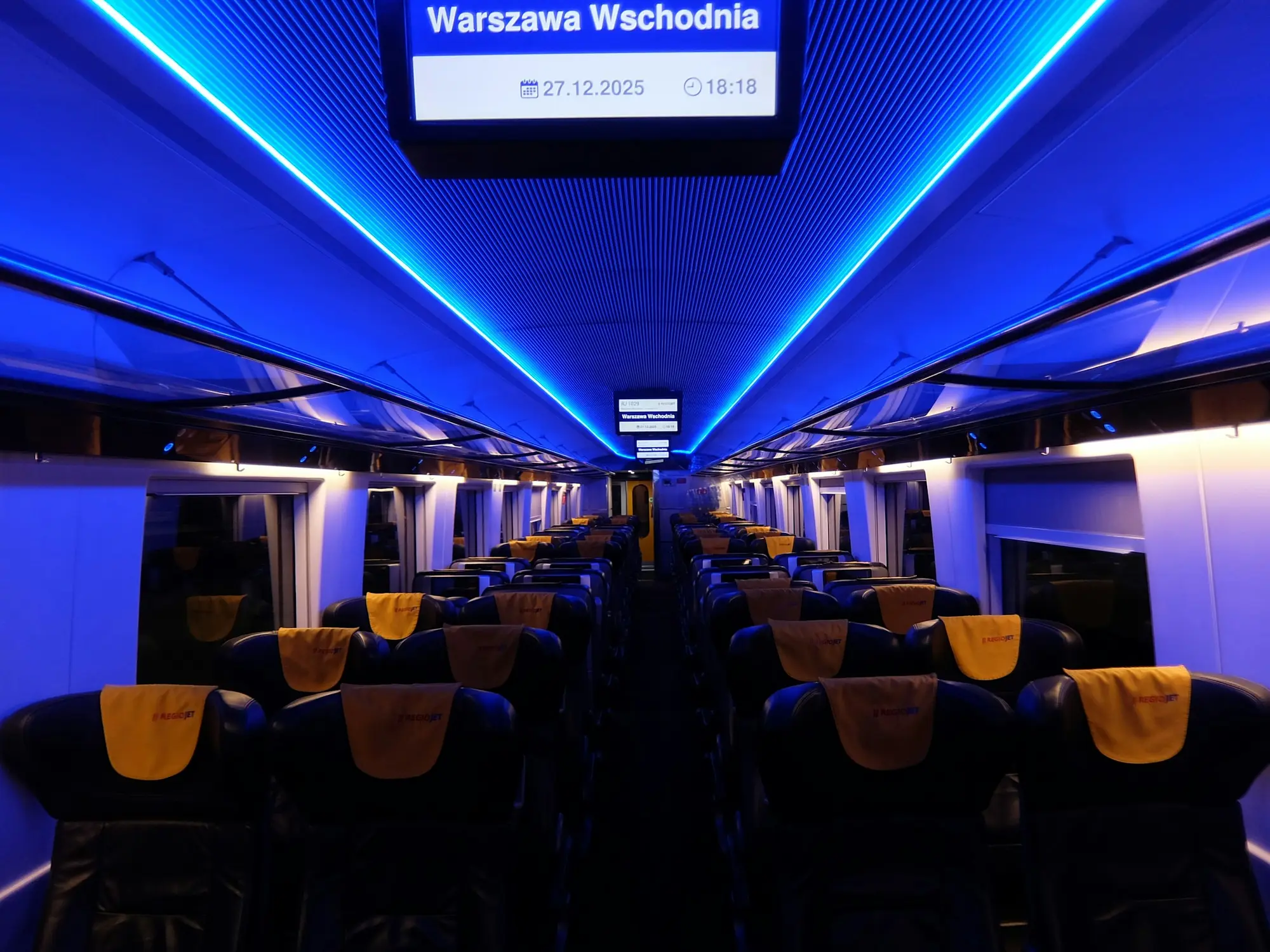 Modern train carriage interior with ambient lighting